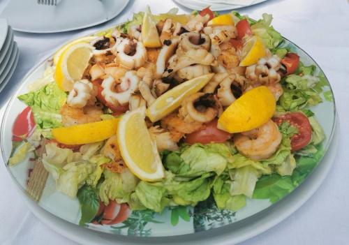 a plate of food with shrimp and lettuce and lemon slices at Hotel Opal in Jupiter
