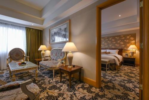 a hotel room with a bed and a large mirror at THE LEES Hotel in Kaohsiung