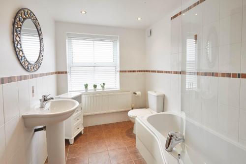 a bathroom with a sink and a tub and a toilet at Host & Stay - Harbour View House in Whitby