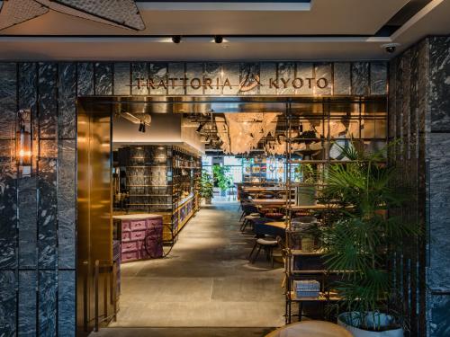 a restaurant with a lobby with tables and plants at Mercure Kyoto Station in Kyoto
