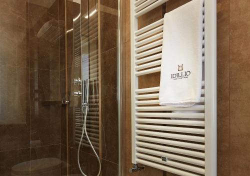 a bathroom with a shower and a towel on a wall at IDILLIO YOUR LUXURY ROOMS in Pescara