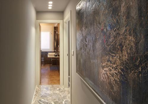 a hallway with a large painting on the wall at IDILLIO YOUR LUXURY ROOMS in Pescara