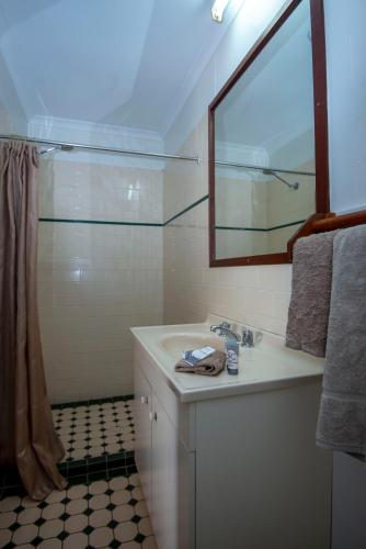 a bathroom with a sink and a mirror at Longreach Most Central Motel in Longreach