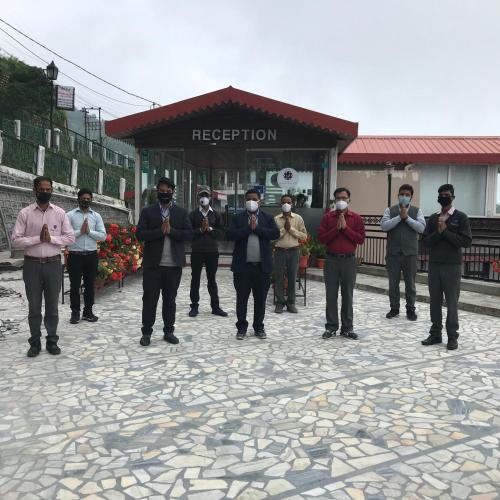 a group of men standing in front of a building at Hotel Vishnu Palace in Mussoorie