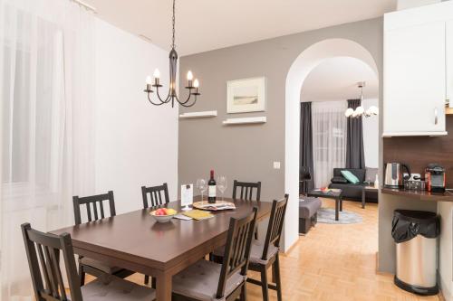 a dining room and living room with a table and chairs at Stephansdom Premium Apartments in Vienna