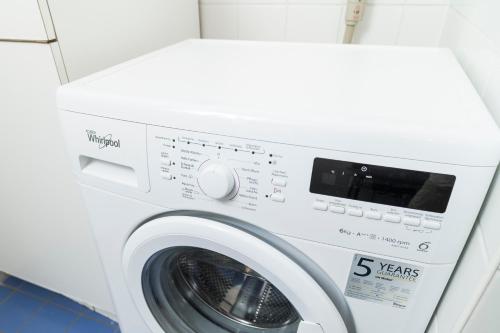 a white washing machine in a laundry room at Stephansdom Premium Apartments in Vienna