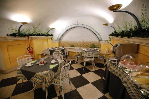 a dining room with tables and chairs and an archway at Hotel S. Anna in Rome