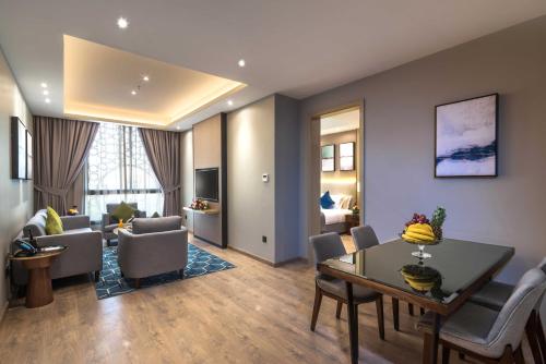 a living room with a table and a dining room at Braira Al Yarmouk in Riyadh