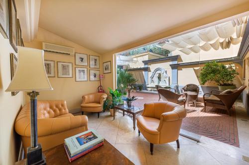 uma sala de estar com mobiliário laranja e uma grande janela em Hotel S. Anna em Roma