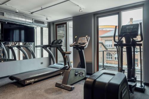 a gym with several exercise bikes and a window at Radisson RED Aarhus in Aarhus