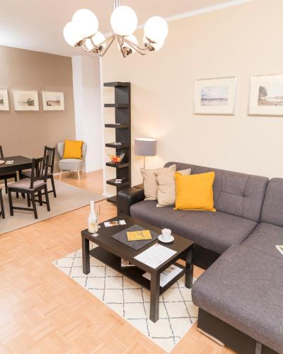 a living room with a couch and a table at Stephansdom Premium Apartments in Vienna