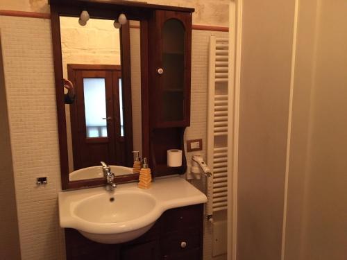 a bathroom with a sink and a mirror at B&B San Martino in Martina Franca
