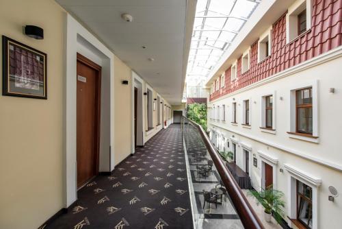 a large building with a stairway leading to a hallway at Amberton Cathedral Square Hotel Vilnius in Vilnius