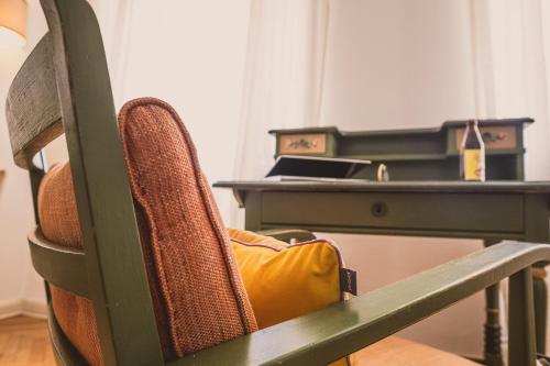 a chair in front of a desk with a laptop at Das Bräu ORIGINAL in Lofer