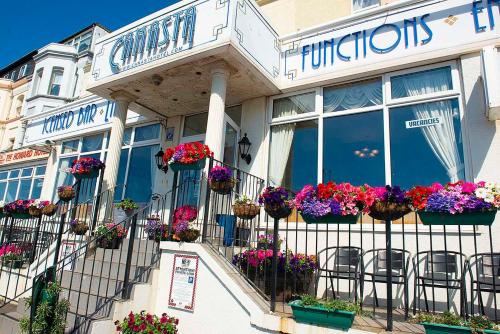 a building with flowerpots on the balcony of a flower shop at Canasta Hotel in Blackpool
