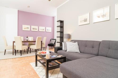 a living room with a couch and a table at Stephansdom Premium Apartments in Vienna