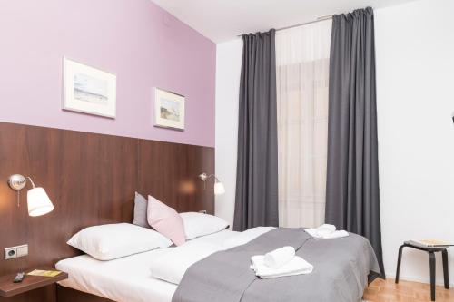 a hotel room with two beds and a window at Stephansdom Premium Apartments in Vienna
