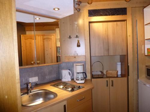 a small kitchen with a sink and a counter at Ferienwohnungen Hauser in Waidring