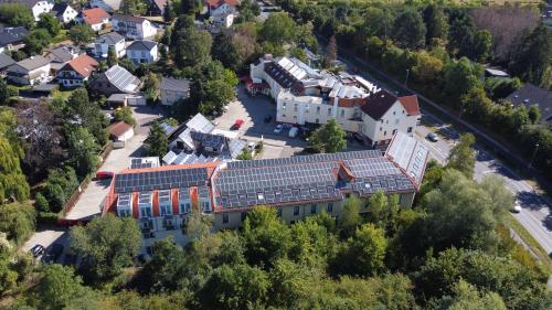 an aerial view of a building with solar panels on its roof at City Hotel Meckenheim in Meckenheim