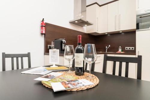 a table with two bottles of wine and two glasses at Stephansdom Premium Apartments in Vienna