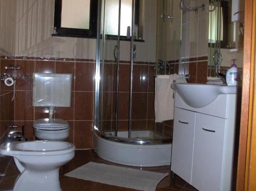 a bathroom with a toilet and a sink and a shower at Rooms Bero in Senj