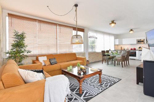 a living room with a couch and a table at Agaete Beach Rental at Volcanic Natural Pools by VillaGranCanaria in Agaete