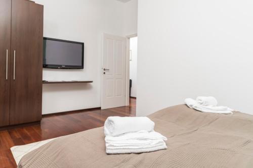 a bedroom with a bed with white towels on it at Stephansdom Premium Apartments in Vienna