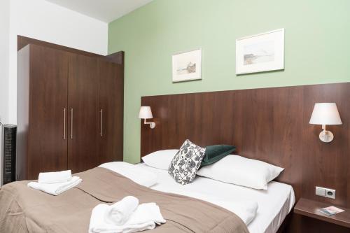 ウィーンにあるStephansdom Premium Apartmentsのベッド2台とタオル2枚が備わるホテルルームです。