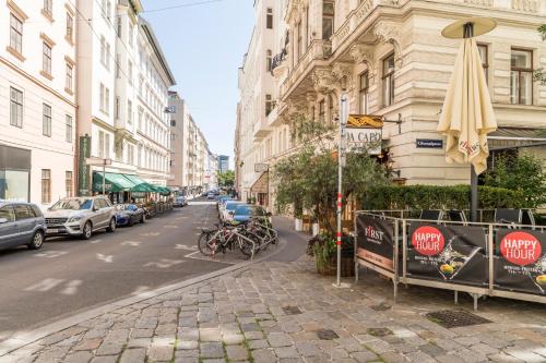 a city street with cars parked on the street at Stephansdom Premium Apartments in Vienna
