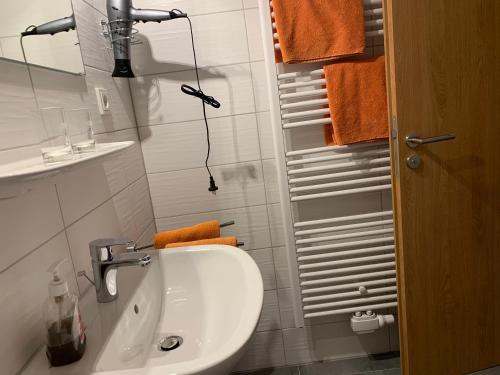a white bathroom with a sink and a mirror at Kubacher Hof in Kubach