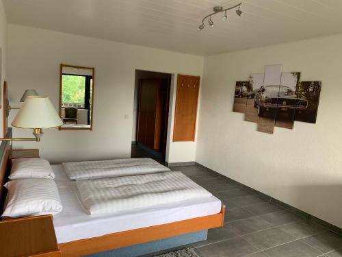 a bedroom with two beds and a picture of a car at Kubacher Hof in Kubach