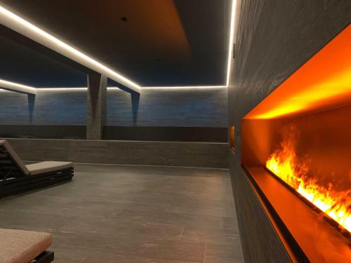 a fireplace in a room with a view of the ocean at LOEV - VELA Hotels in Binz