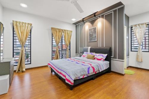 a bedroom with a bed with pink pillows at Suraya Homestay Semi-D in Sepang