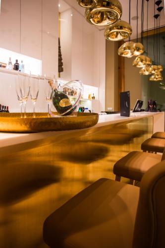 a bar with wine glasses on a counter at Portugal Boutique Hotel in Lisbon