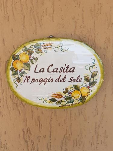 a plate with lemons on it hanging on a wall at La Casita Il Poggio Del Sole in Letojanni