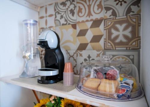a shelf with a blender and some food on it at La Nghioscia in Grottaglie