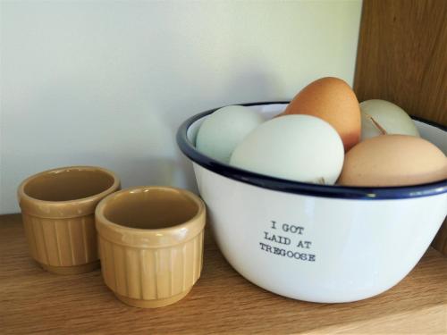 a bowl filled with eggs and two dipping at The Wriggly Tin at Tregoose Old Mill in Newquay