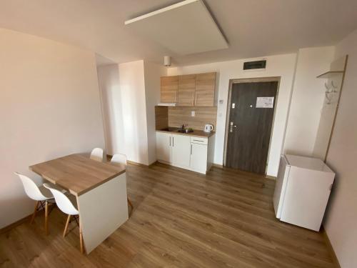 a kitchen with a table and chairs in a room at Hotel Felicia in Kaluža