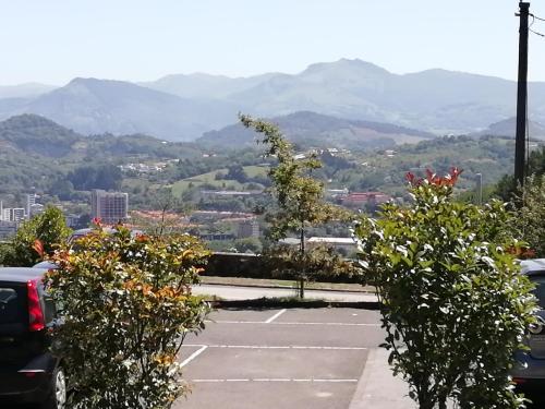 a parking lot with mountains in the background at CR Luarri in Donostia-San Sebastián