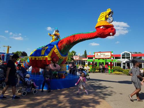 a large dragon float in a fair with people walking by at 5minute walk to LEGO house - private studio room with bathroom in Billund