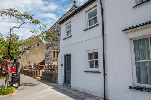ローアーンにあるChapel View- Beautiful central cottage with nearby Restaurants & Castle walkの青い扉のある白い家