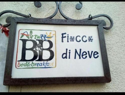 a sign on the side of a building at B&B Fiocco di Neve in Rocca di Mezzo