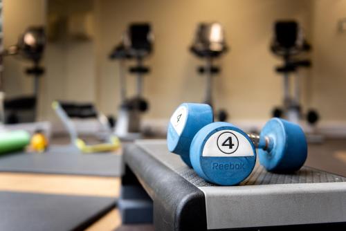 a pair of blue dumbbells on a table in a gym at The Parsonage Hotel & Spa in York