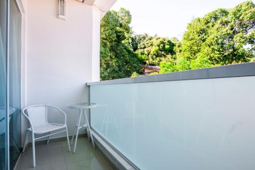 a balcony with a table and a chair at Hotel Ilhabela in Ilhabela