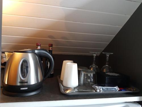 a kitchen counter with a tea kettle and other appliances at ANNO 1919 in Swalmen