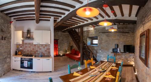 a kitchen and living room with a table and chairs at Monastero San Silvestro in Cortona