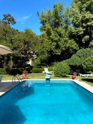 a large swimming pool in a yard with trees at Vila Duparchy in Luso