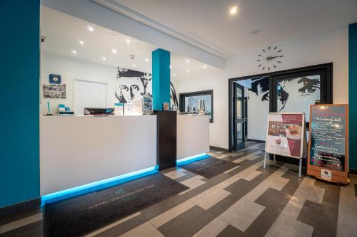 a store with a counter with blue lights in a room at Hotel Deutscher Hof in Kassel