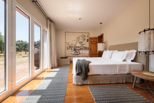 a bedroom with a bed and a large window at A Casa do Governador in Évora