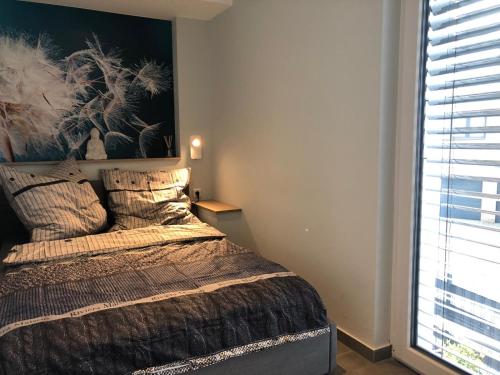 a bedroom with a bed and a large window at Guetsel-Lodge - Δ in Gütersloh